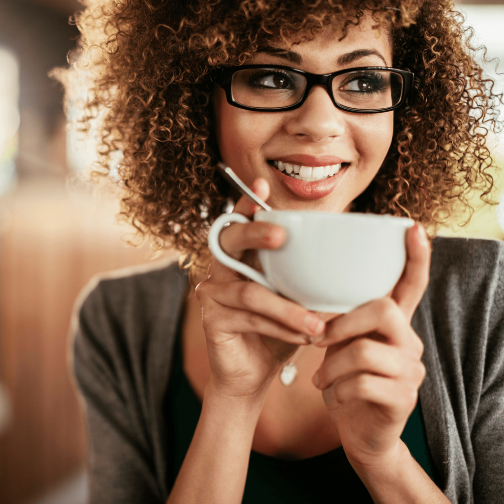 Woman enjoying a coffee and smiling