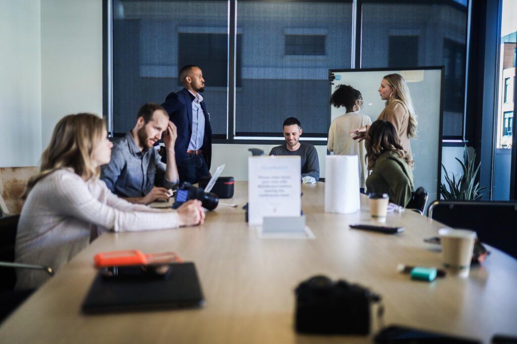 coworkers sitting at table for meeting | Innovators Central